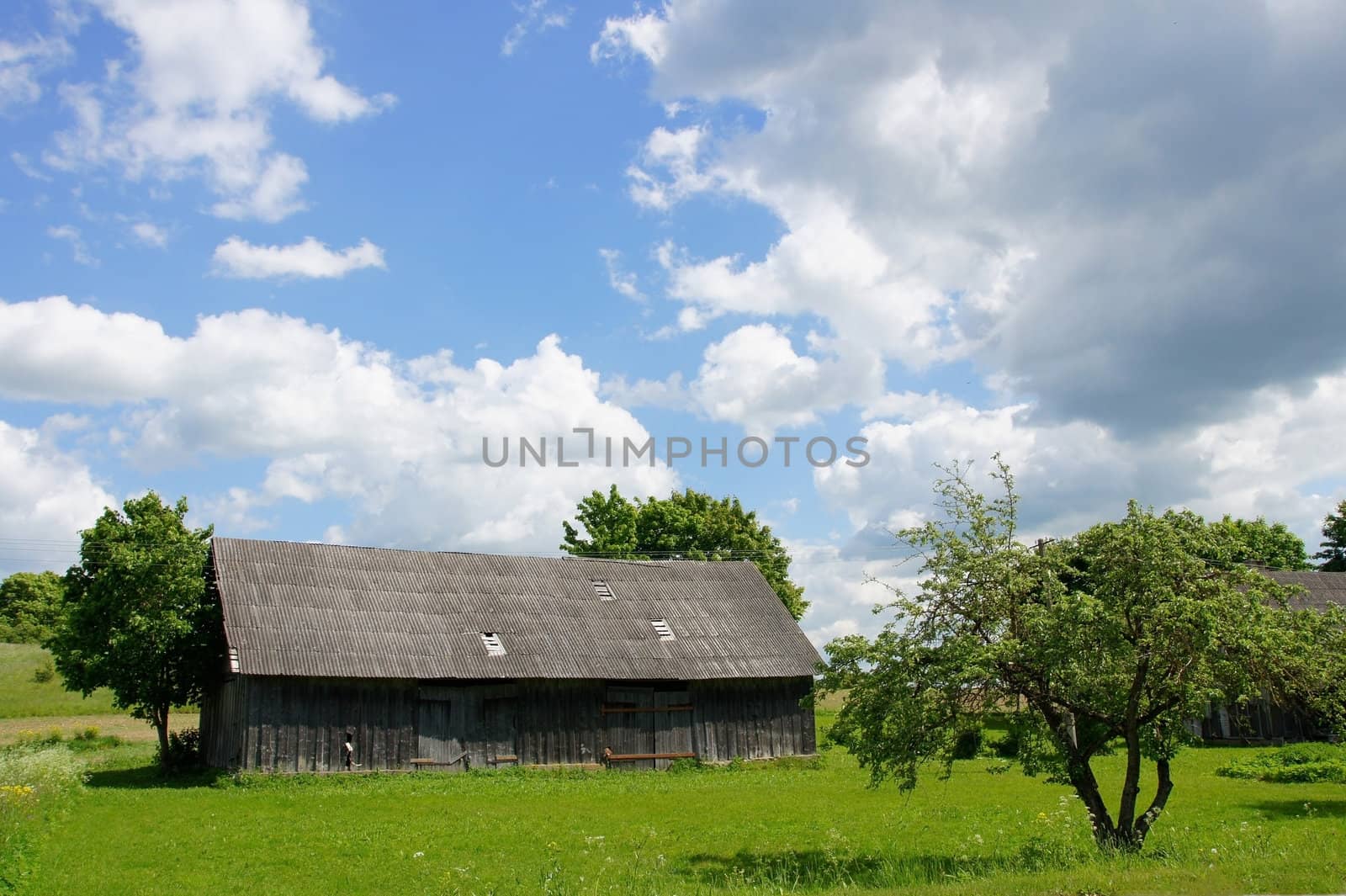 Wooden shed on a background of the cloudy sky