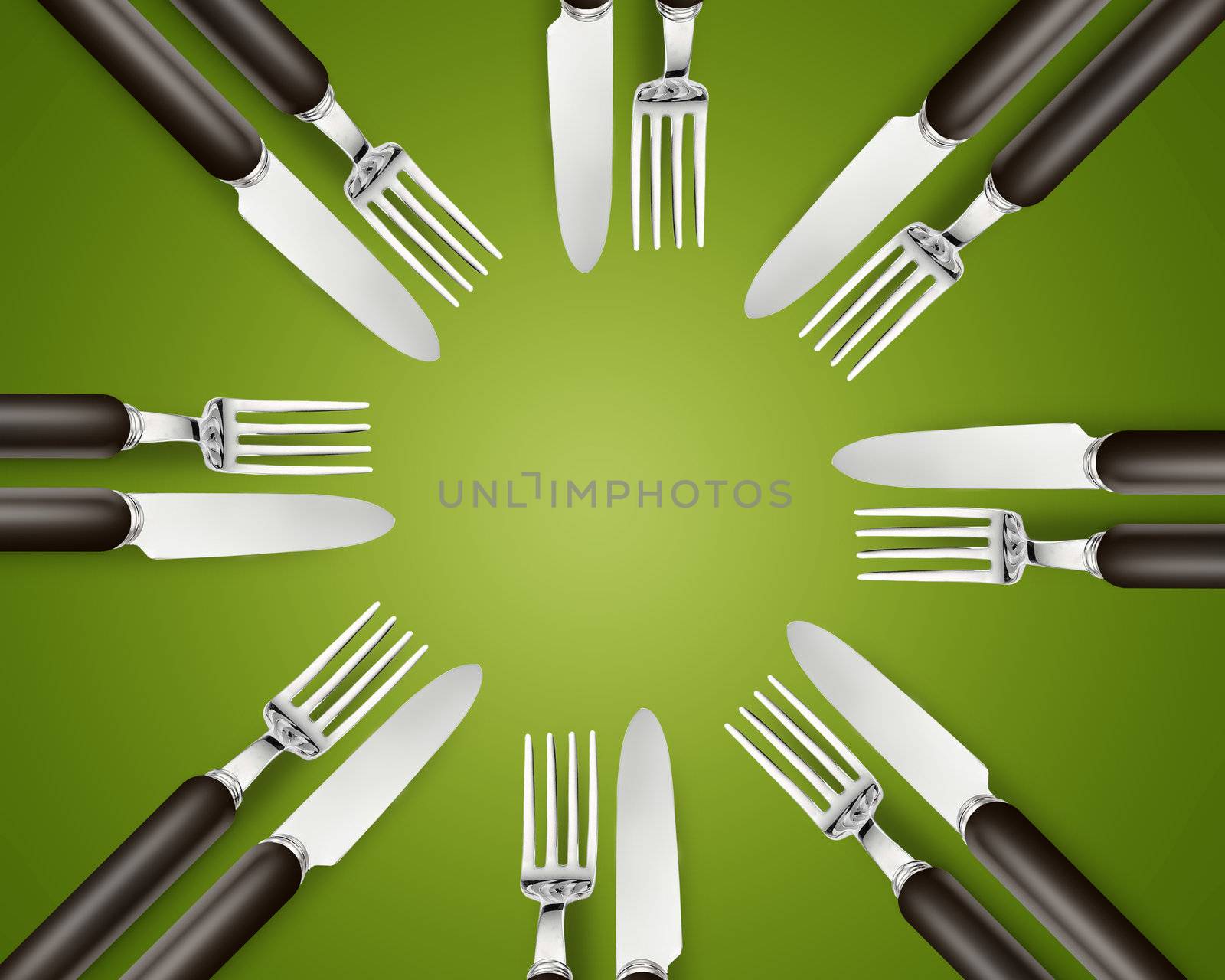 Empty copy space circle in set of knives and forks on green background.