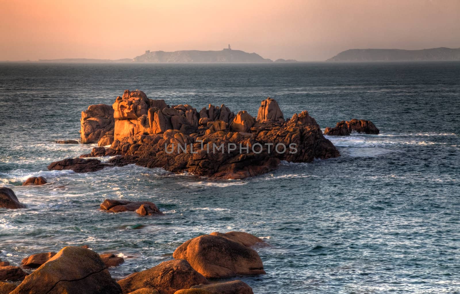 Beautiful sunset over the rocks of Pink Granite Coast in Brittany in the northwest part of France.