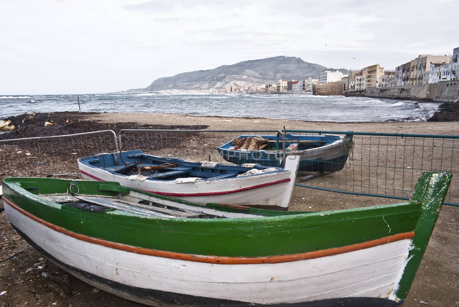 Boats in the marina of trapani with old buildings and sky cloudy