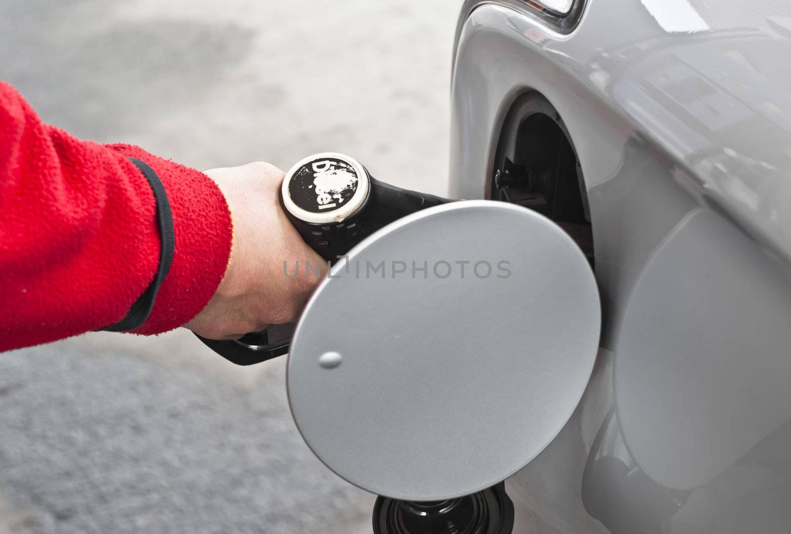 A man filling tank with diesel