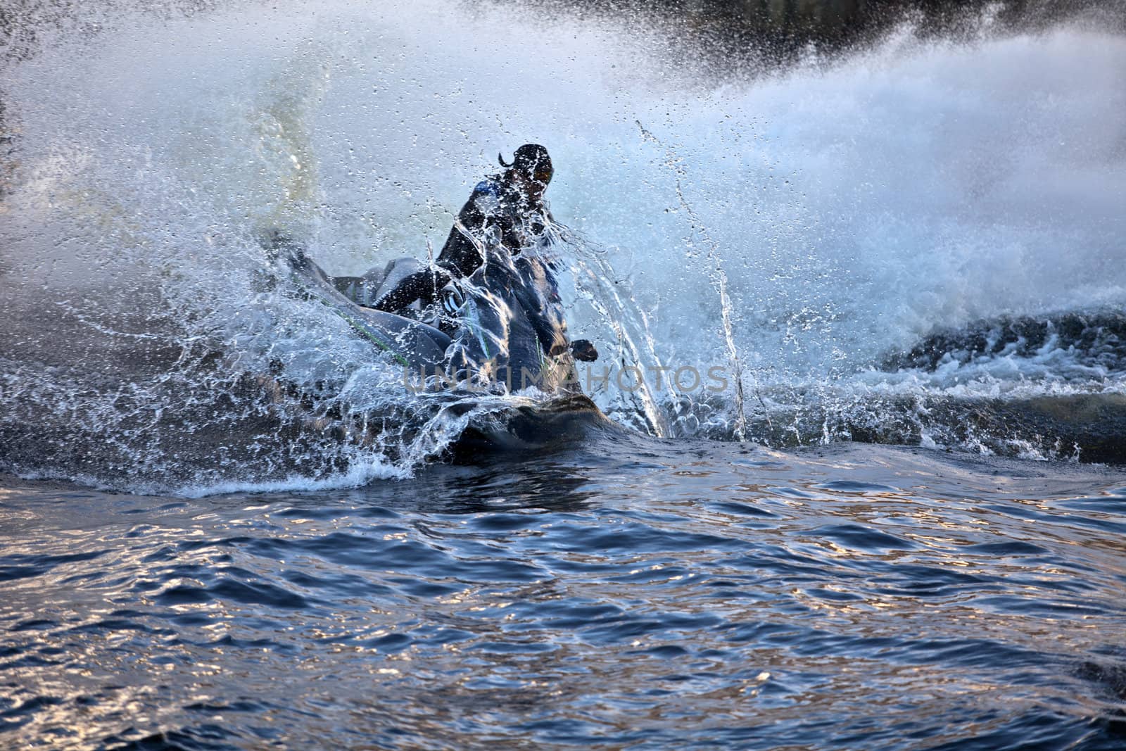jet ski at high speed lifts a large wave