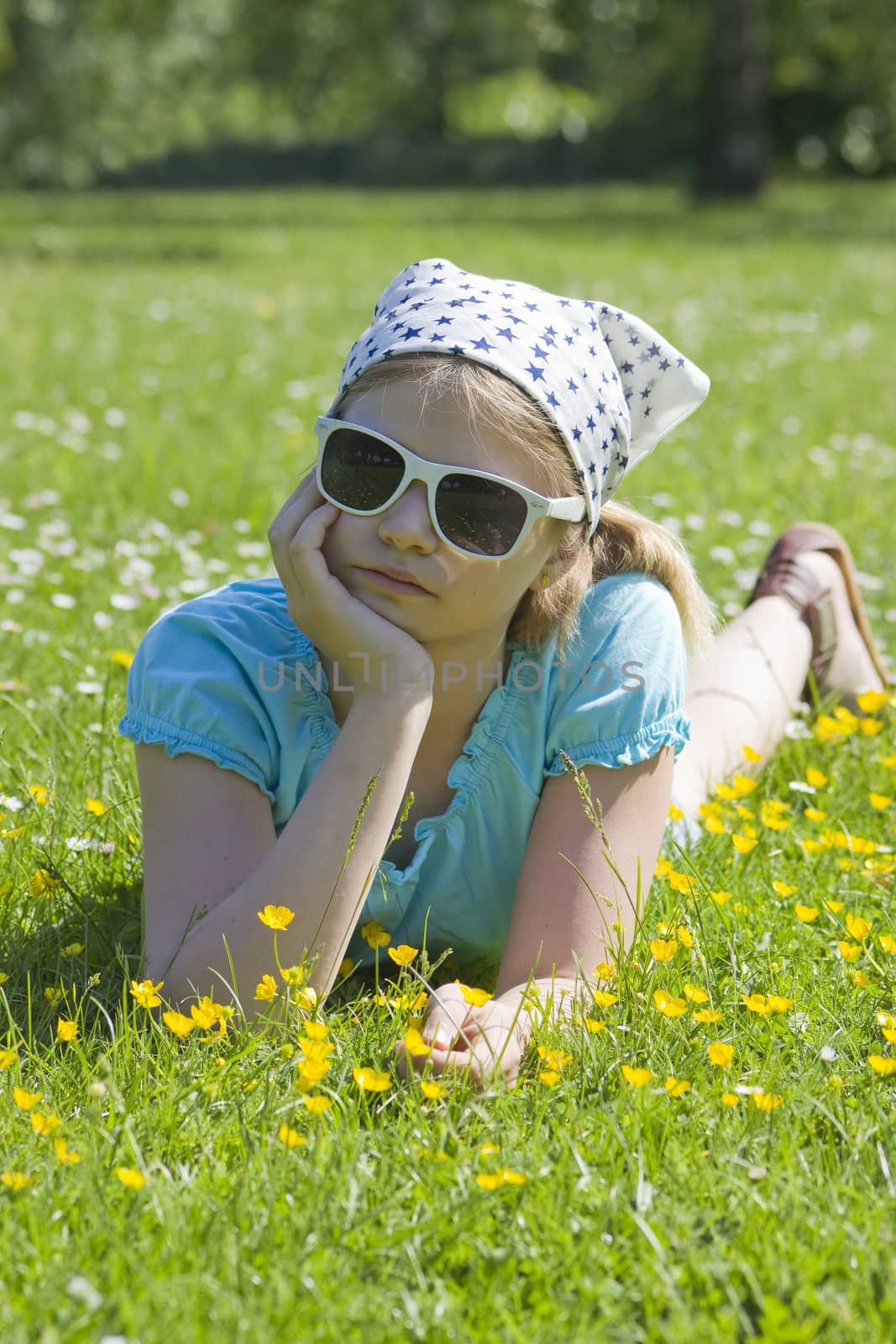 little girl lying on grass  by miradrozdowski