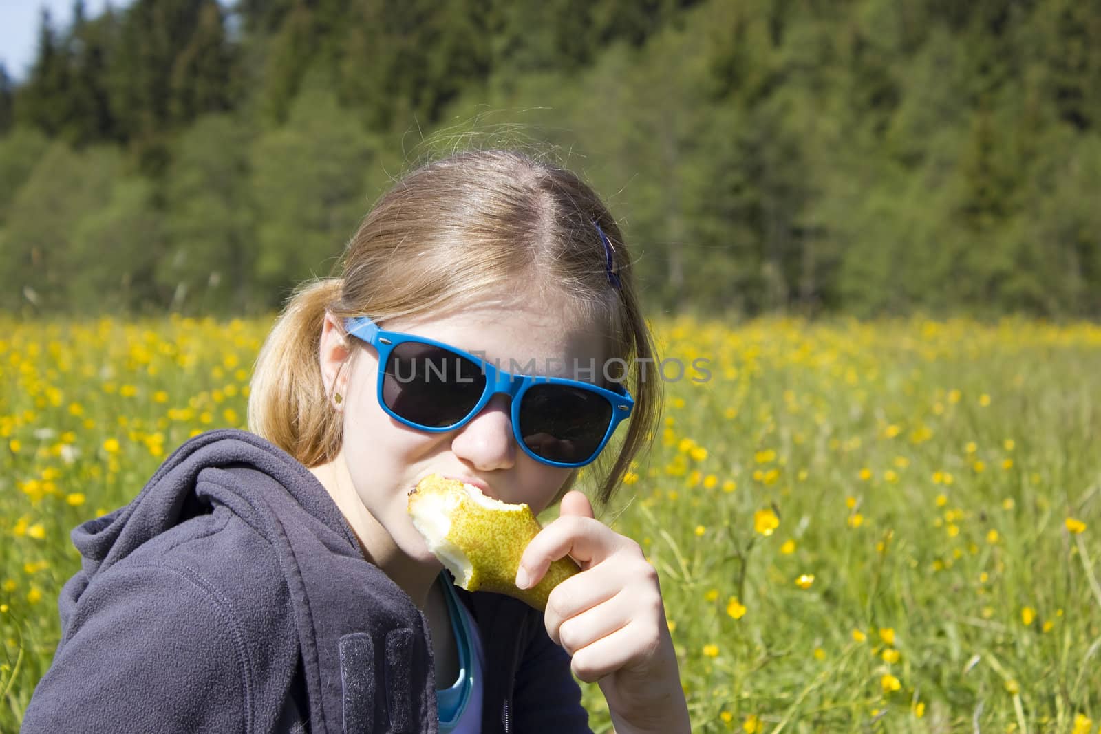 Young girl with fresh yellow pear by miradrozdowski