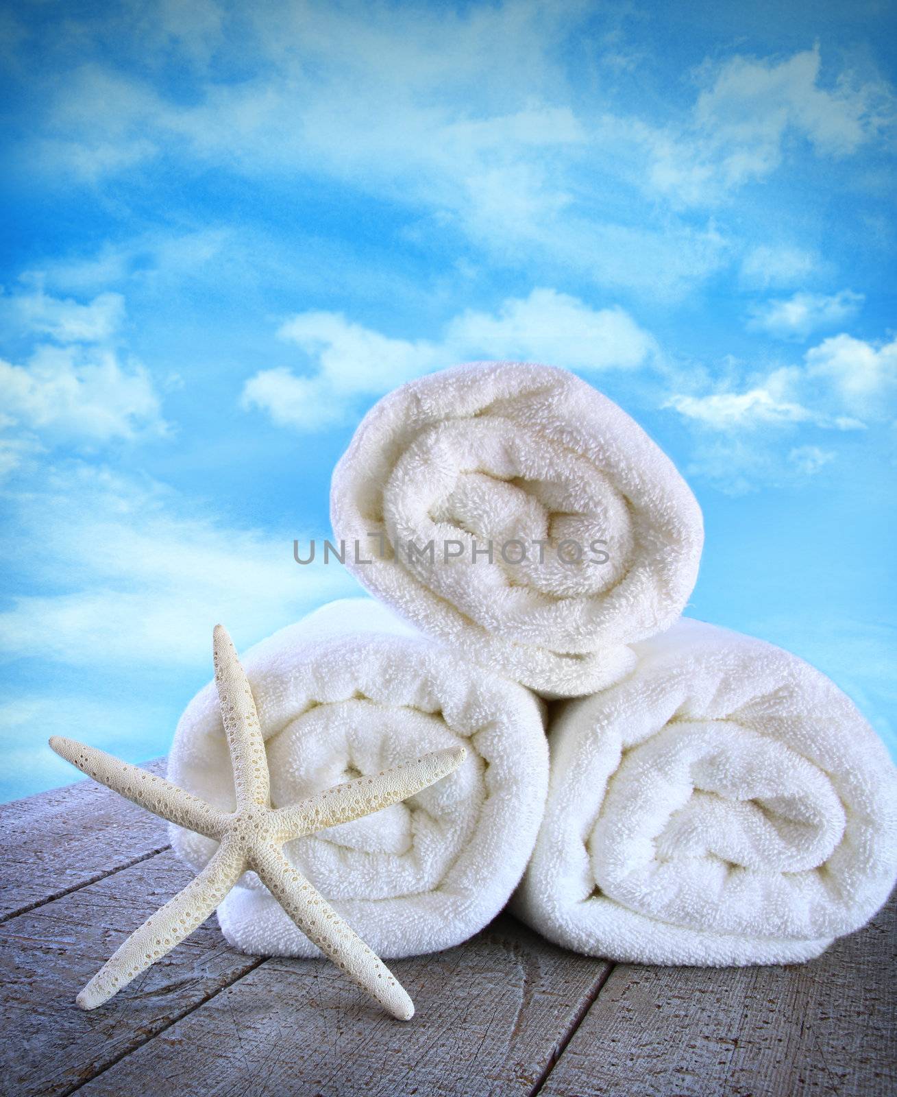 Fluffy fresh towels against a blue sky by Sandralise