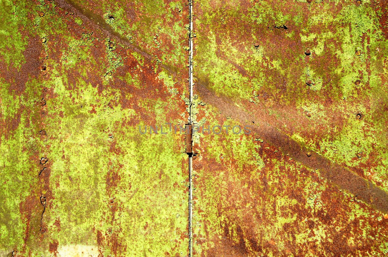 Background of old rusty steel garage door and hinge.