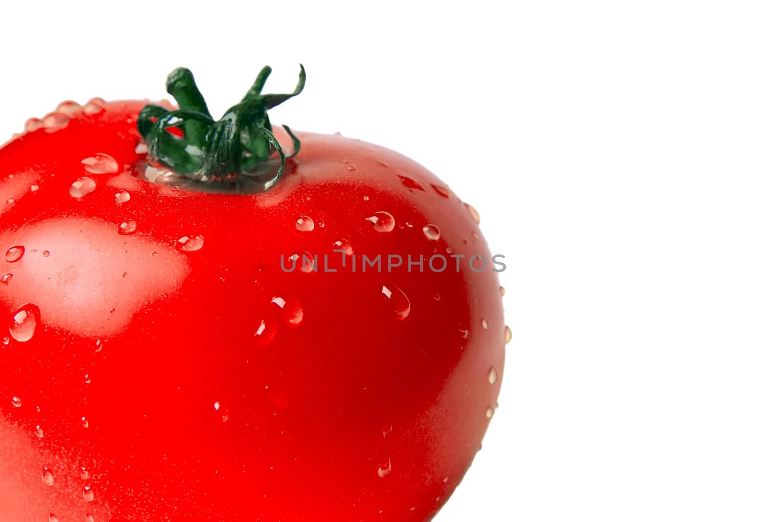 wet tomato at the plate on a white background