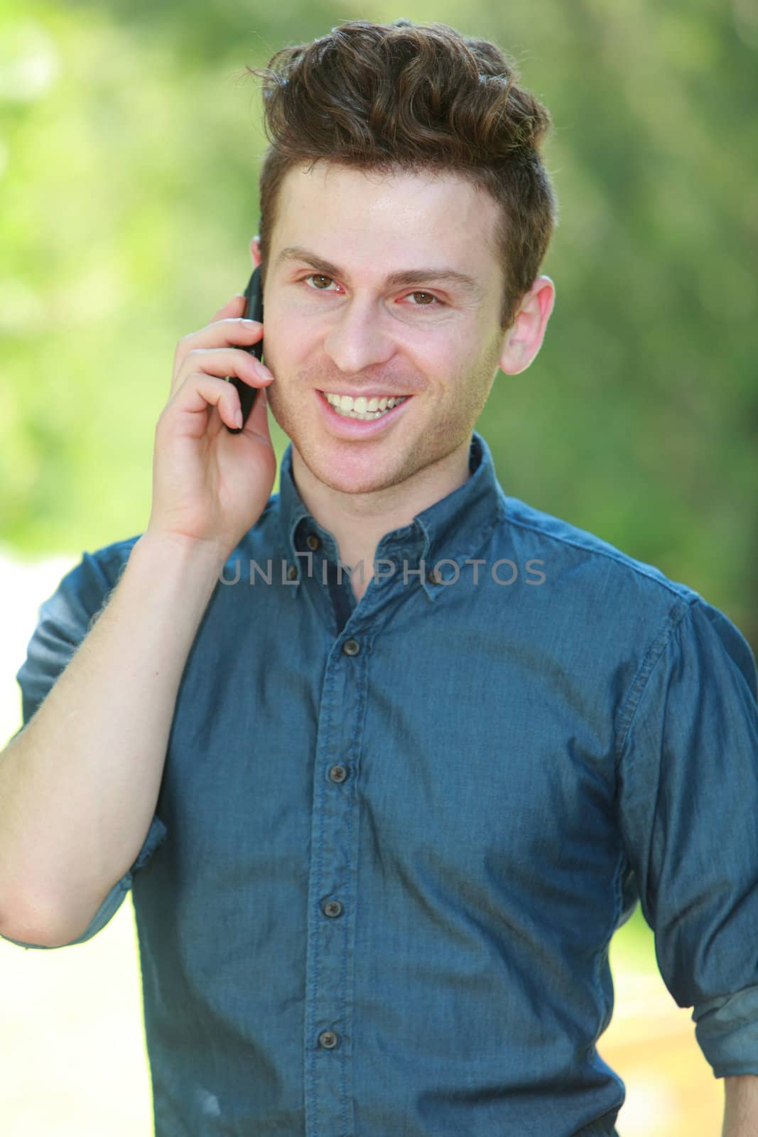 Portrait of young red hair man with telephone