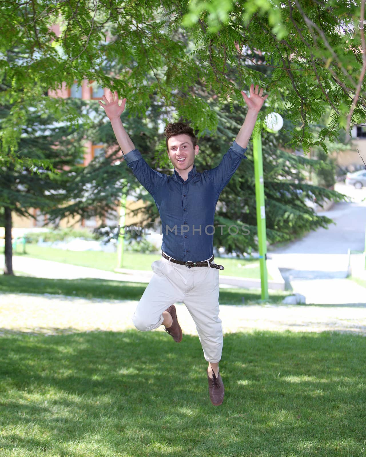 happy and jumping young man in park