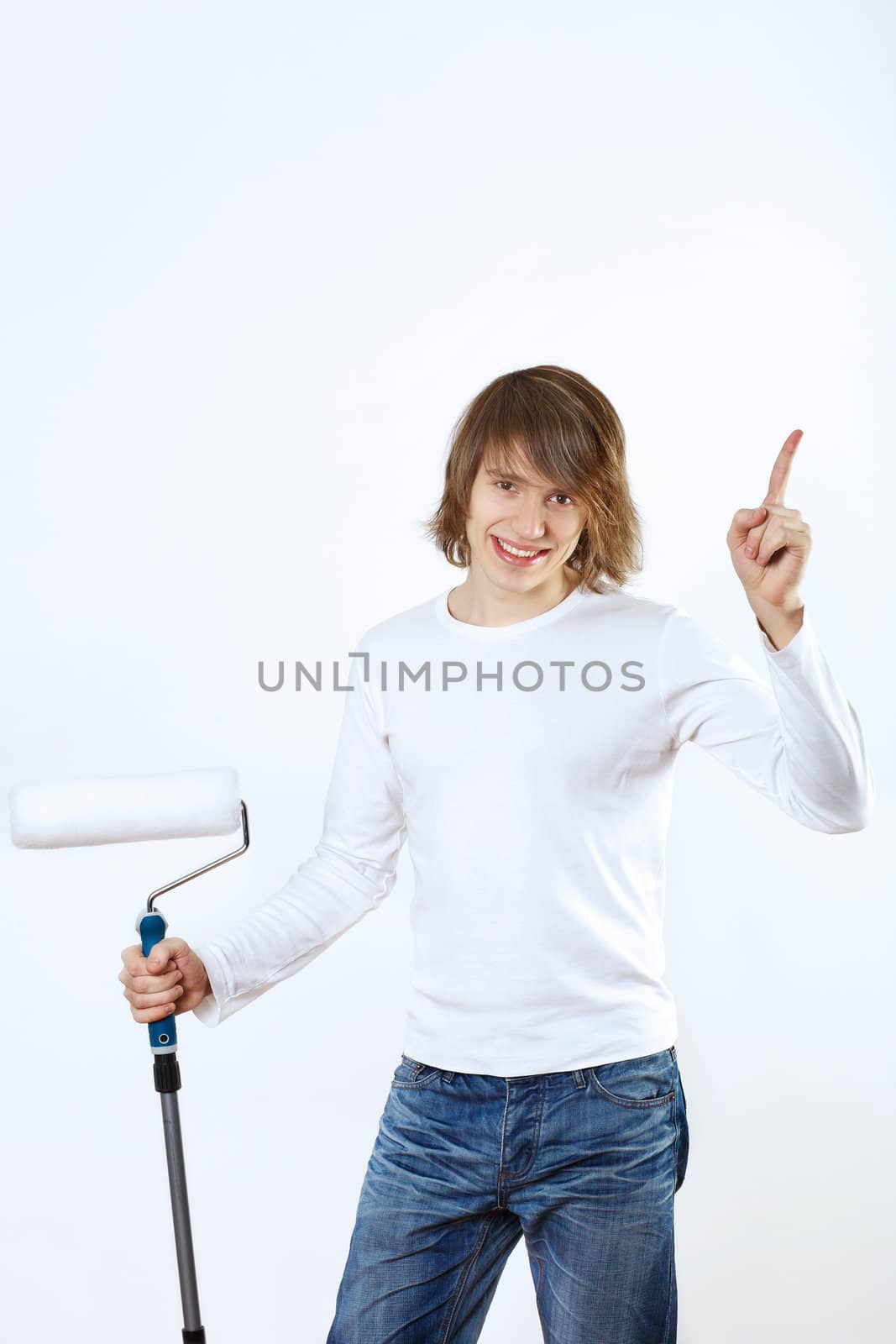 Portrait of young man with paint brushes