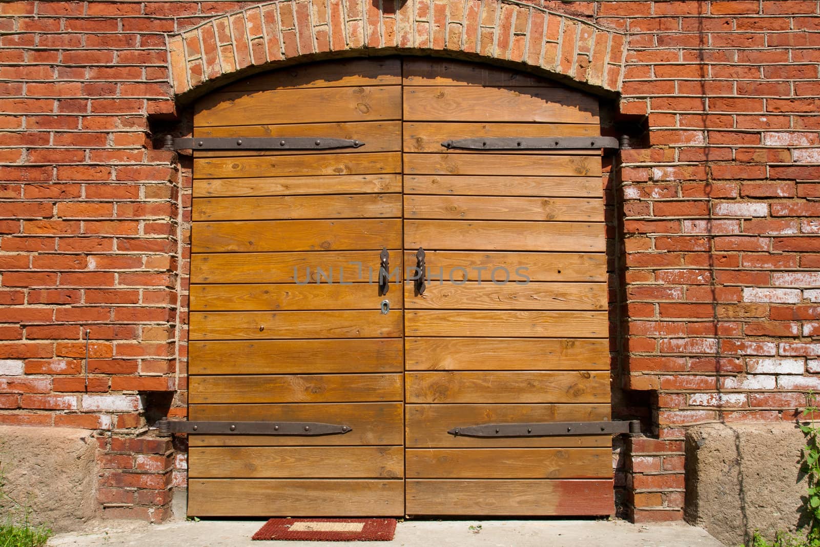 Big wooden doors in red brick wall