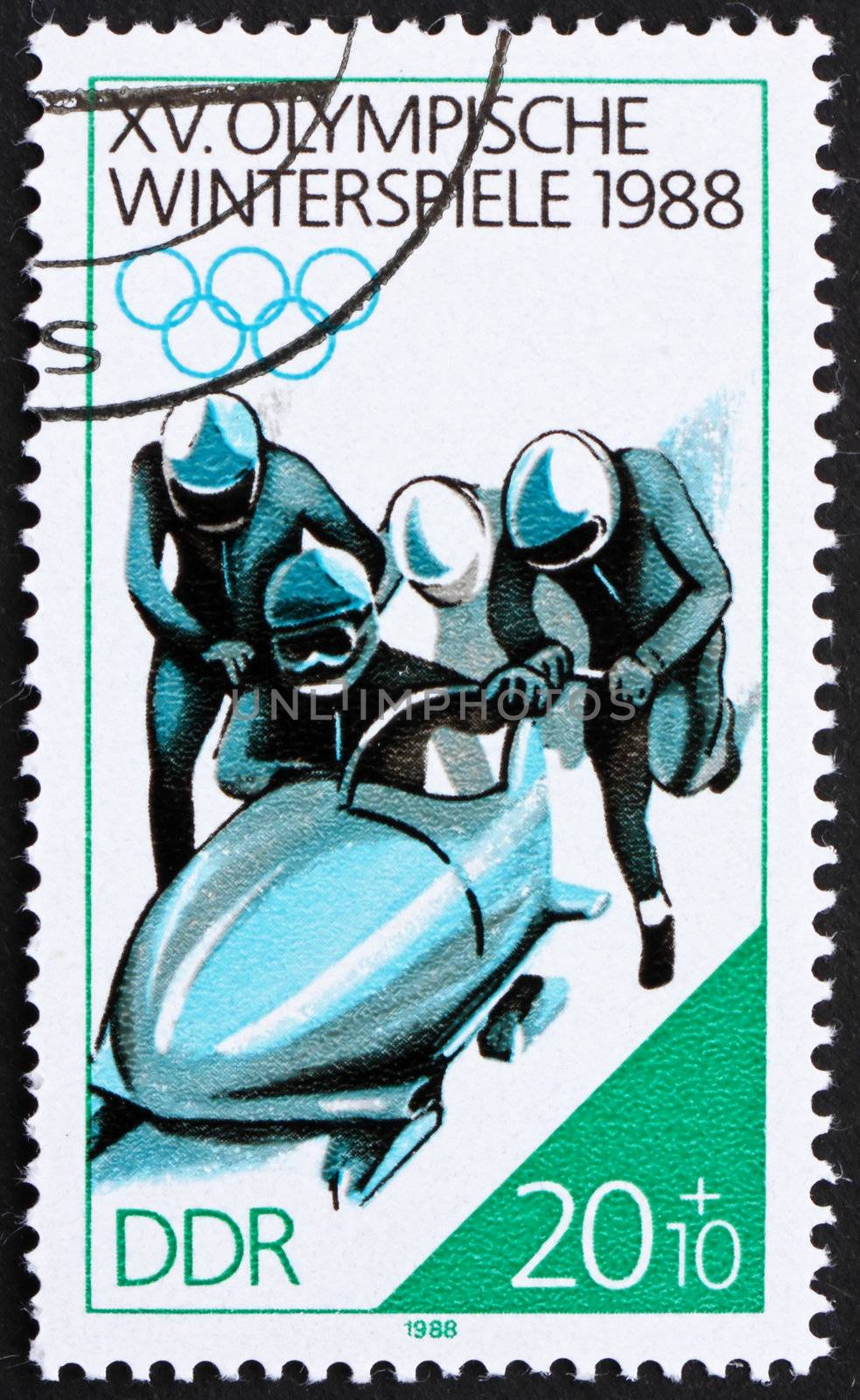 GDR - CIRCA 1988: a stamp printed in GDR shows 4-man Bobsled, 15th Winter Olympics, Calgary, Canada, circa 1988