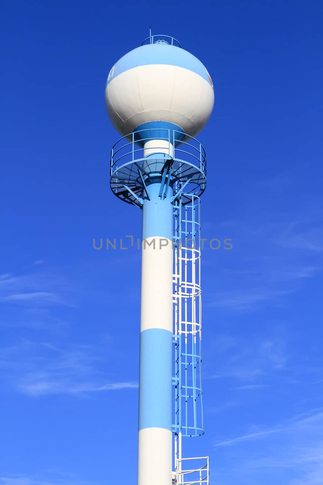 Water tower against blue sky