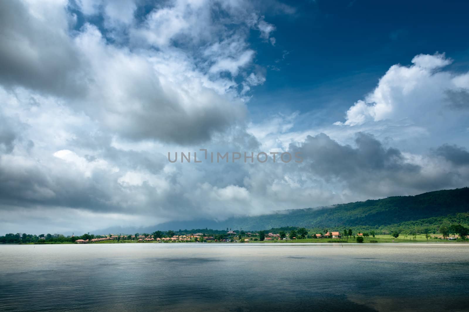 Dark Cloud on blue sky and green Mountain