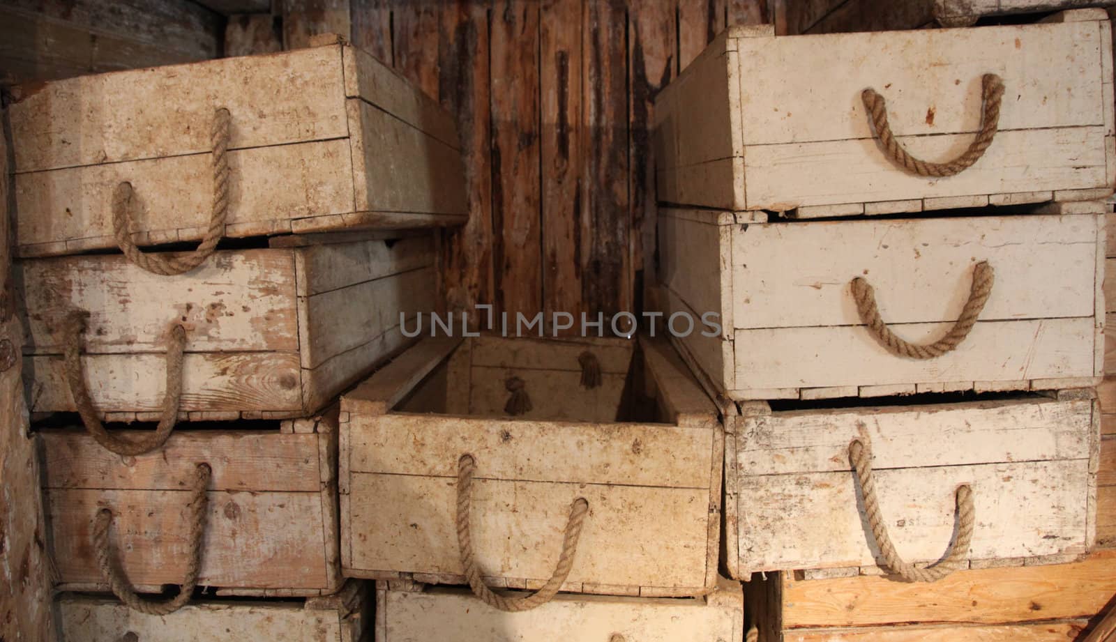 antique wooden boxes with rope handles in an old warehouse in Norway