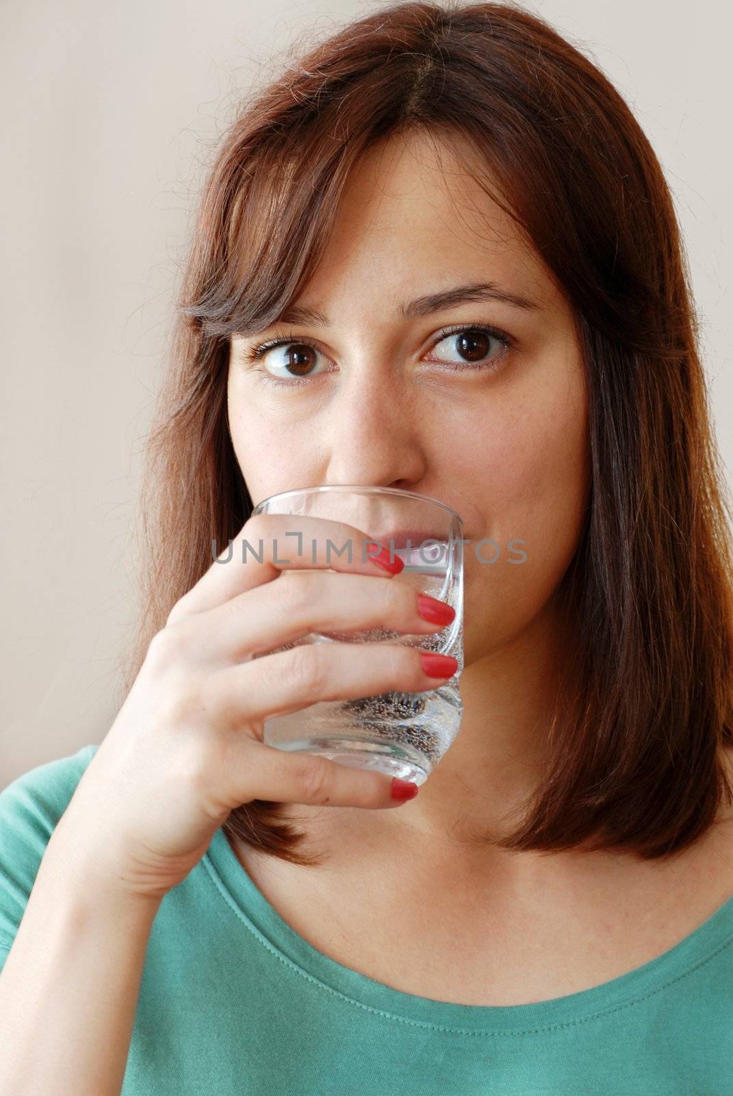 Young woman drinking water by simply