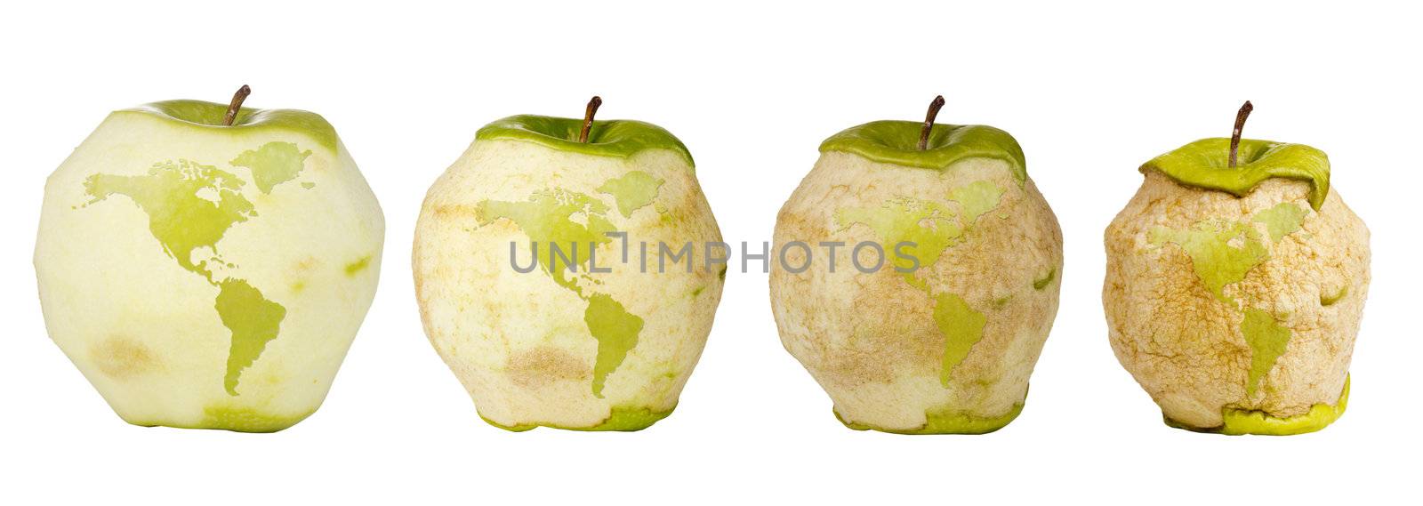 Green apple with a carving of the world map shown four times over a timespan of its deterioration.