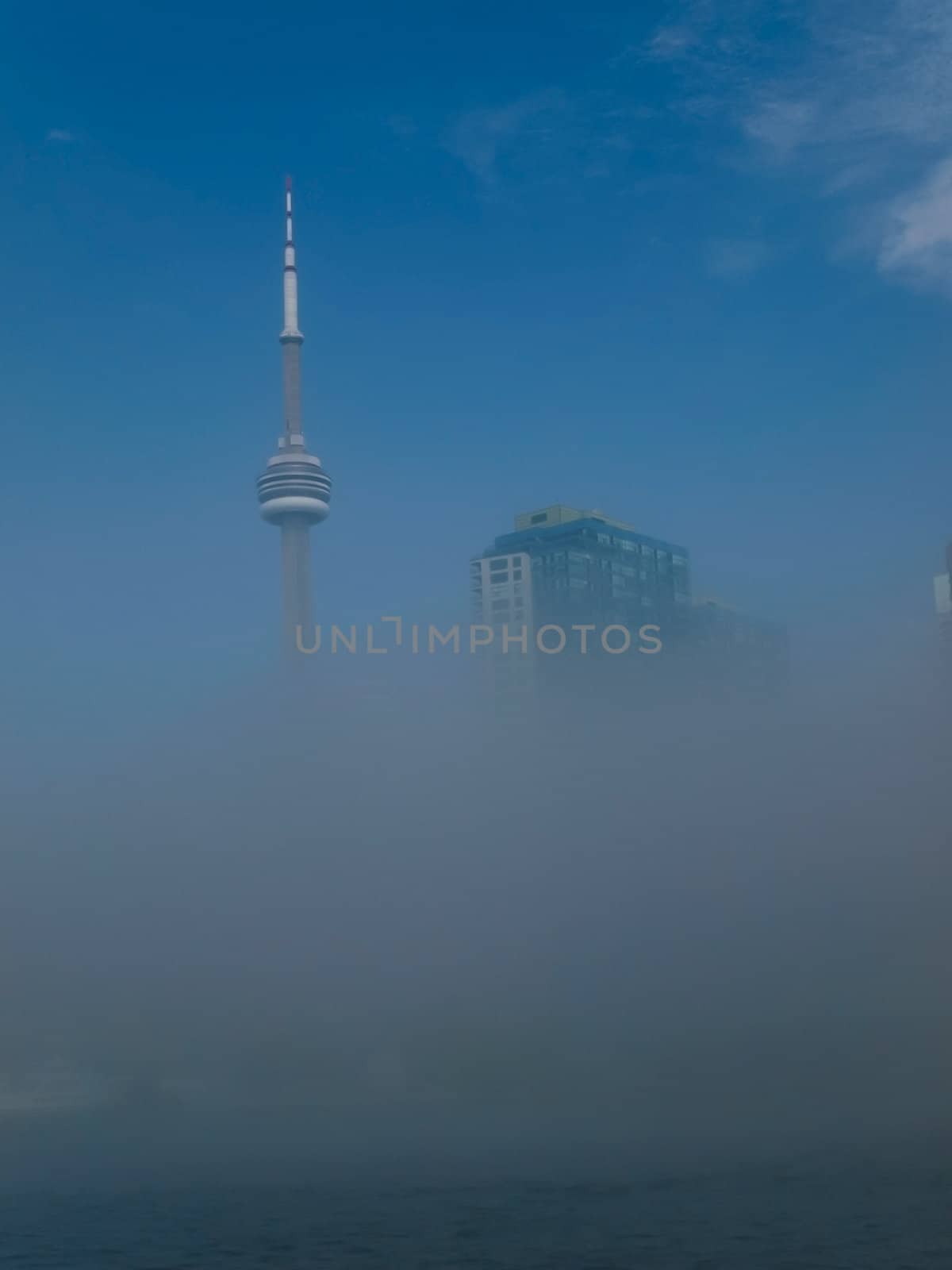 C. N. Tower. Toronto. Canada. View from Lake Ontario. Morning fogged.