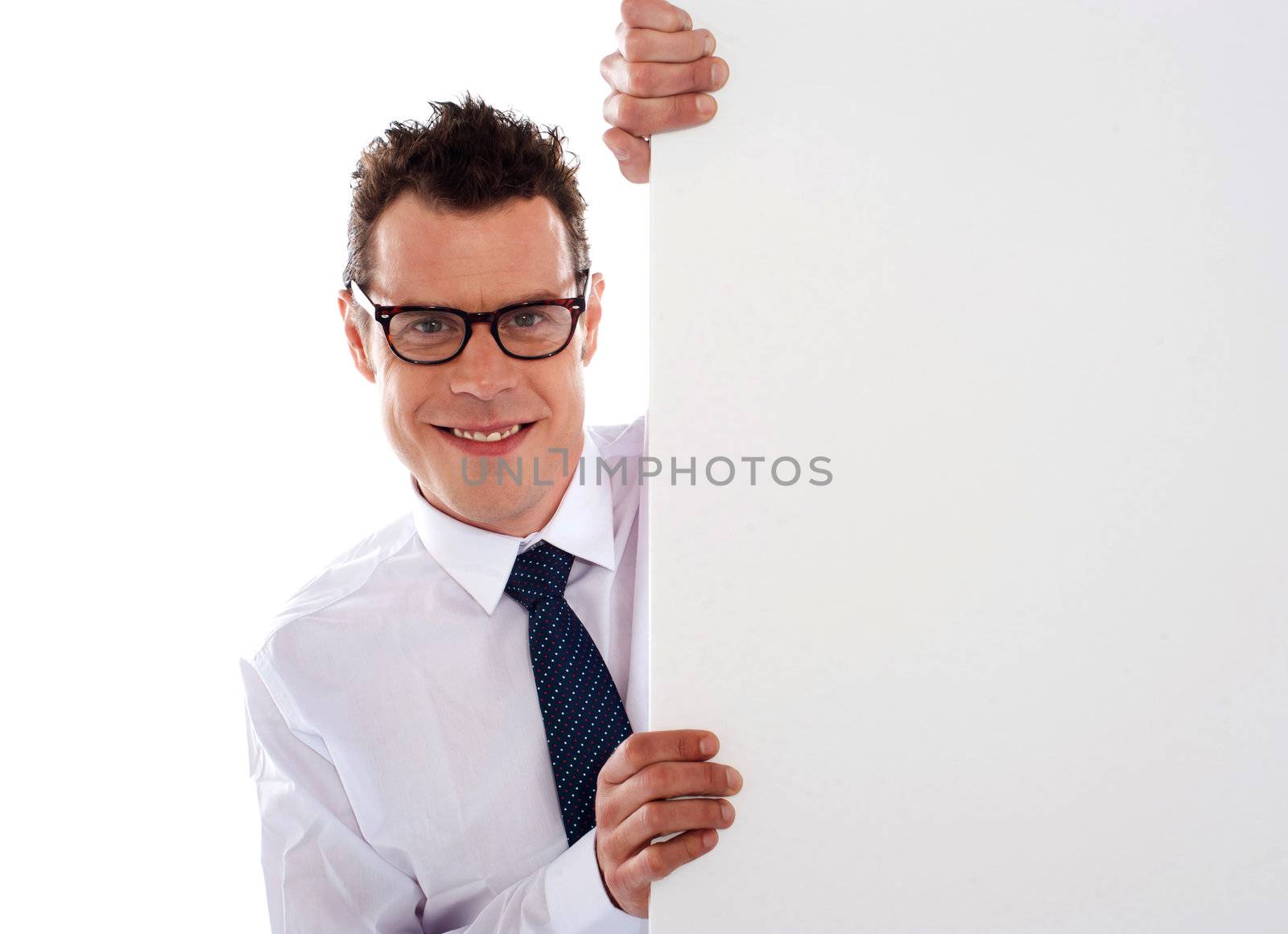 Young man holding a big white blank  signboard and looking at camera