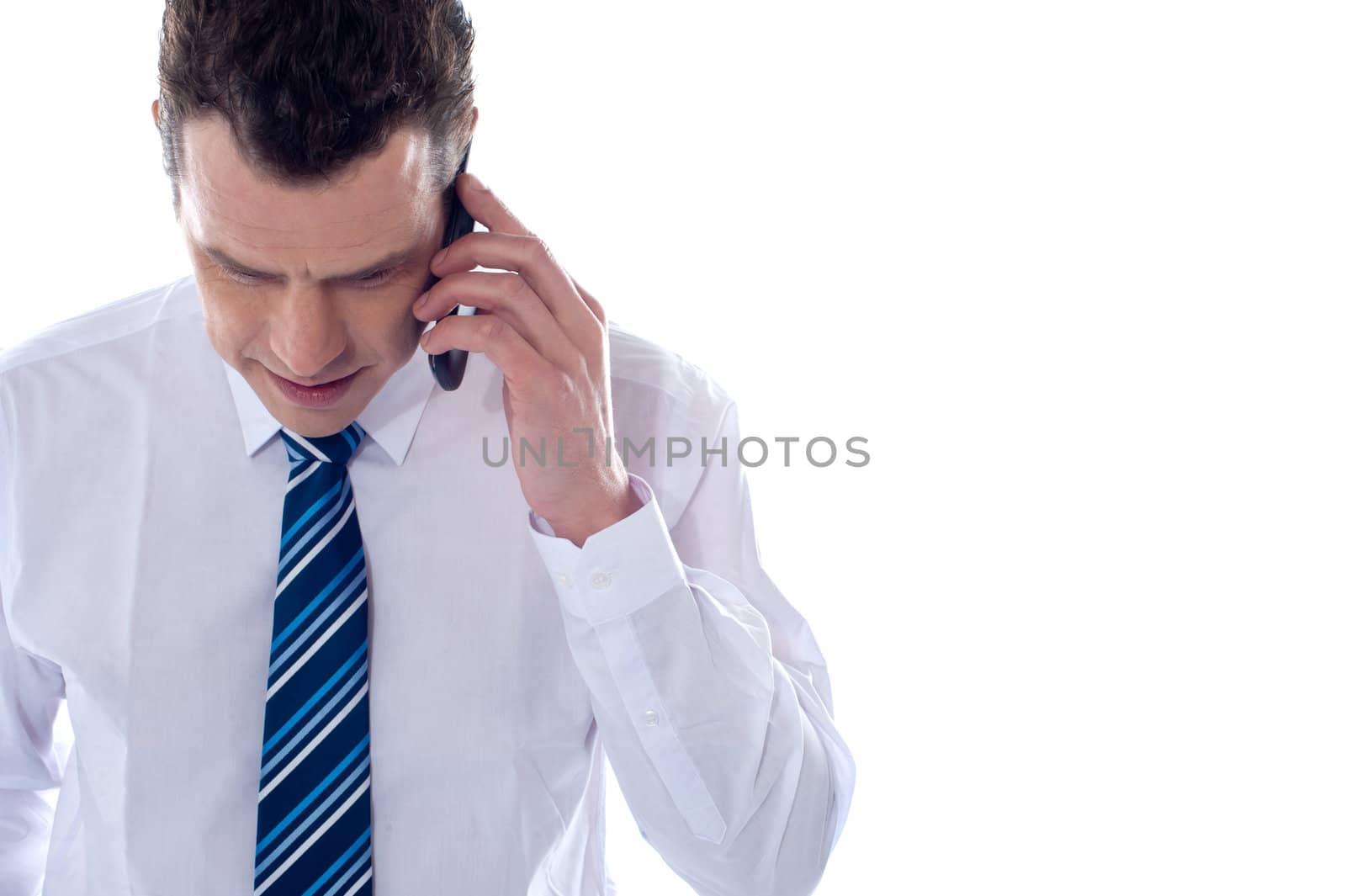 Business professional communicating on phone against white background