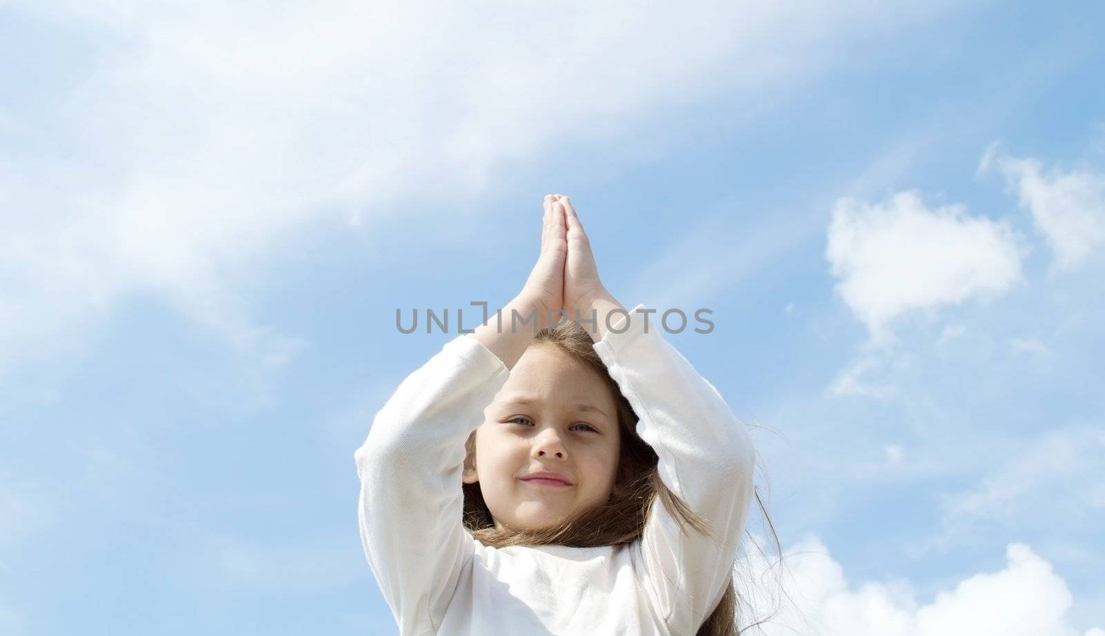 little girl meditates in the sky