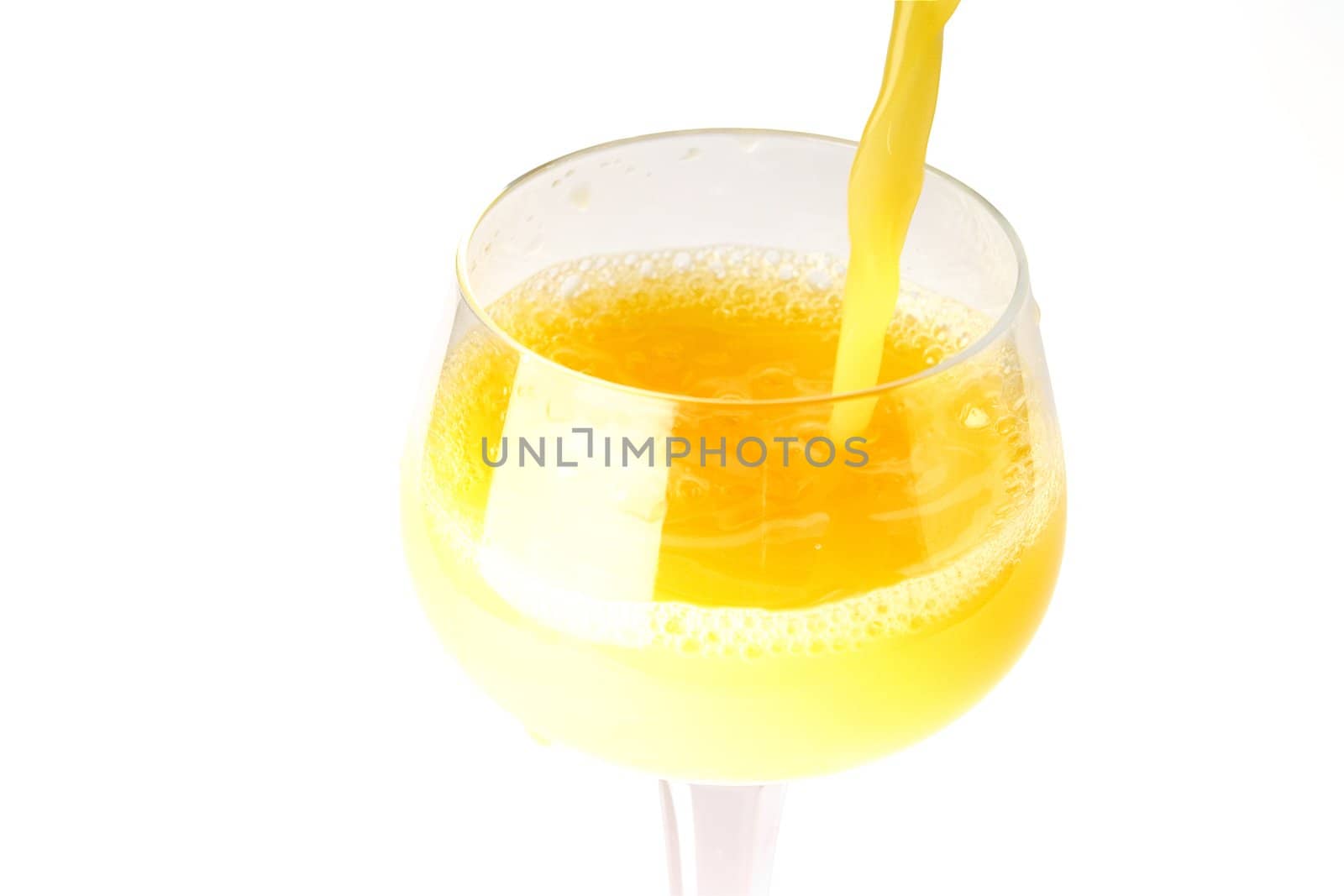fresh brightly yellow orange juice in glass on a white background