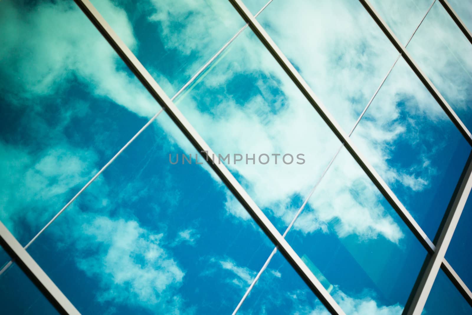 blue sky and white clouds reflected in big windows
