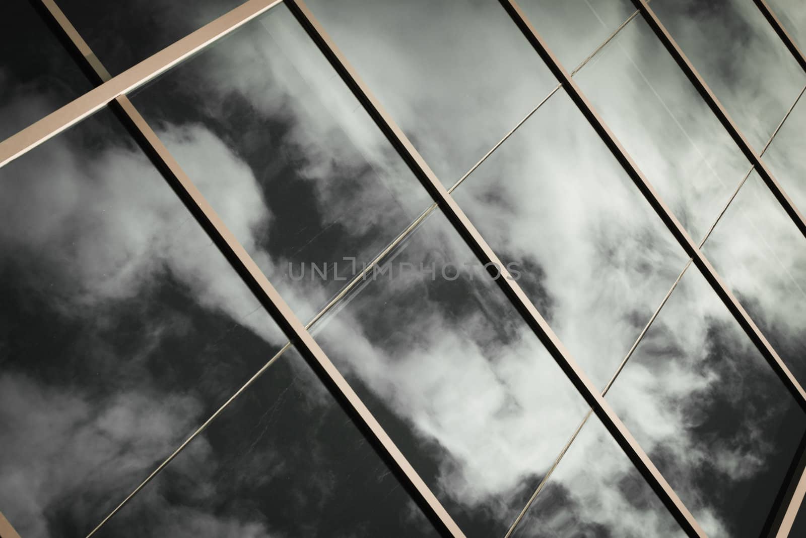 blue sky and white clouds reflected in big windows