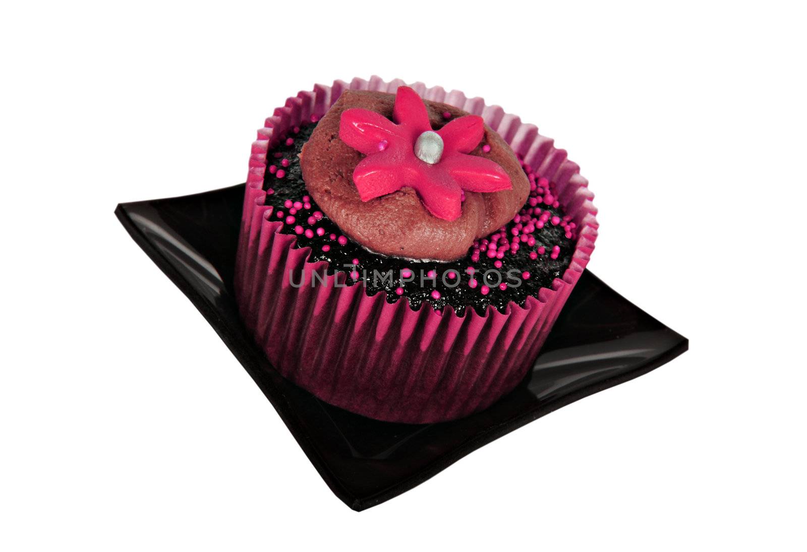 One chocolate cupcake with pink icing on white background