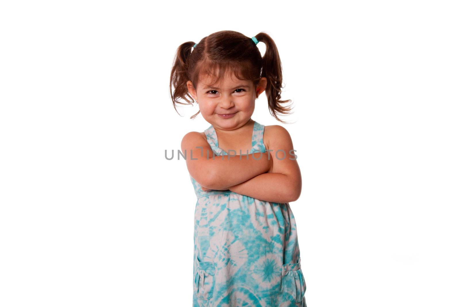 Cute little young toddler girl with attitude smirk, arms crossed and pigtails in hair, naughty rascal expression, isolated.