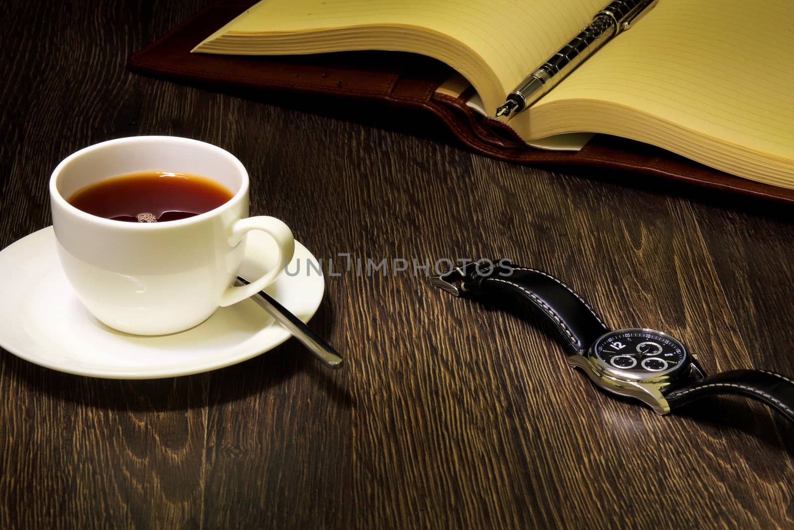 A cup of black coffee and a book