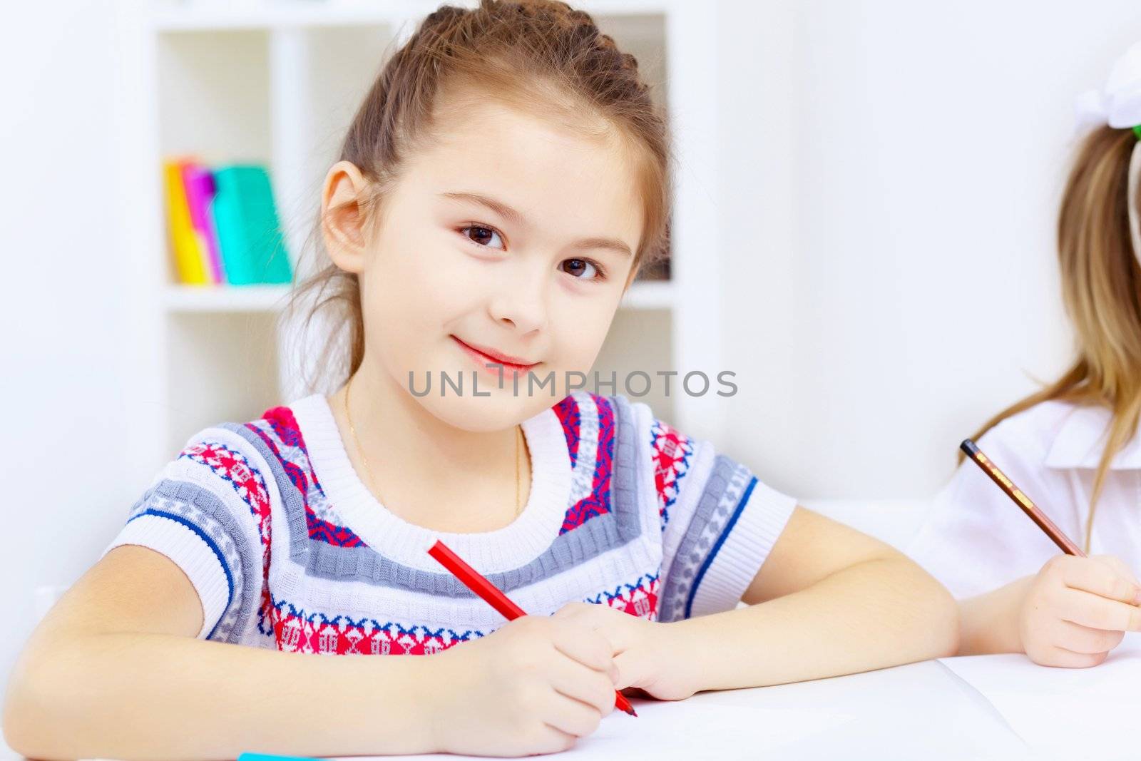 Little girl sitting and studying at home