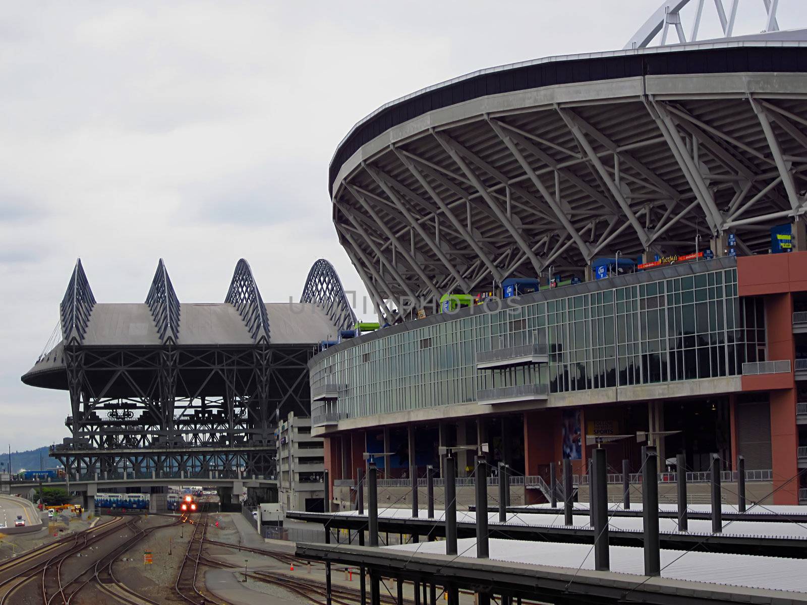 A photograph of a commuter train near a sports stadium.