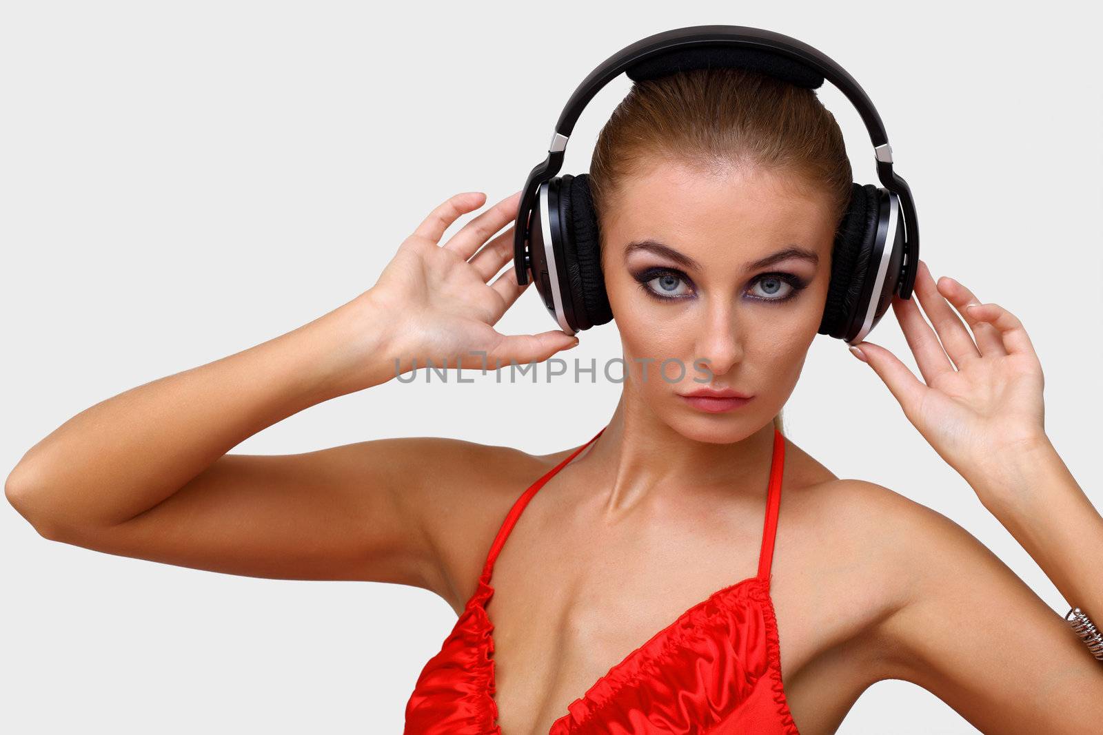 Portrait of young woman with headphones in studio