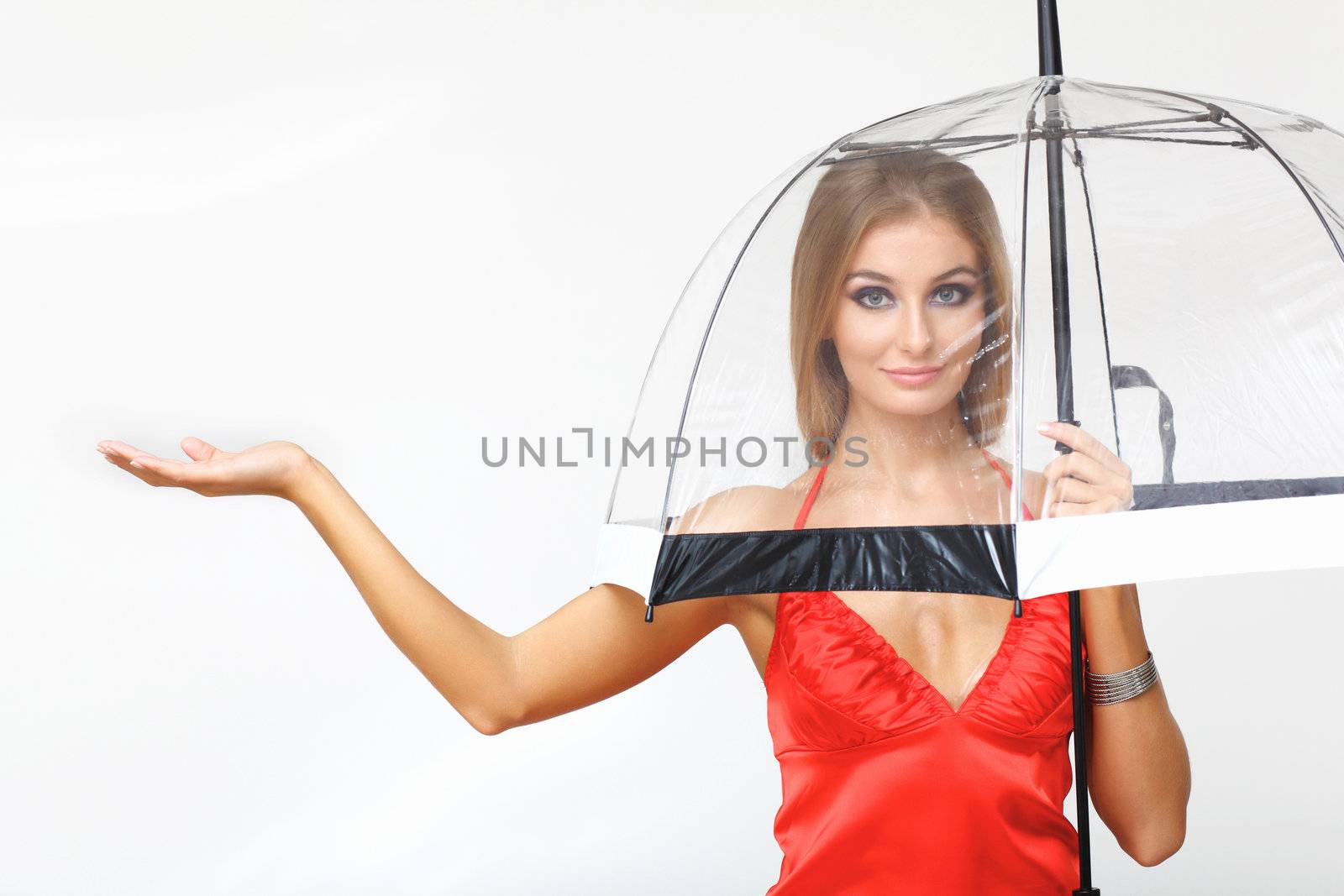 Portrait of young woman with umbrella in studio