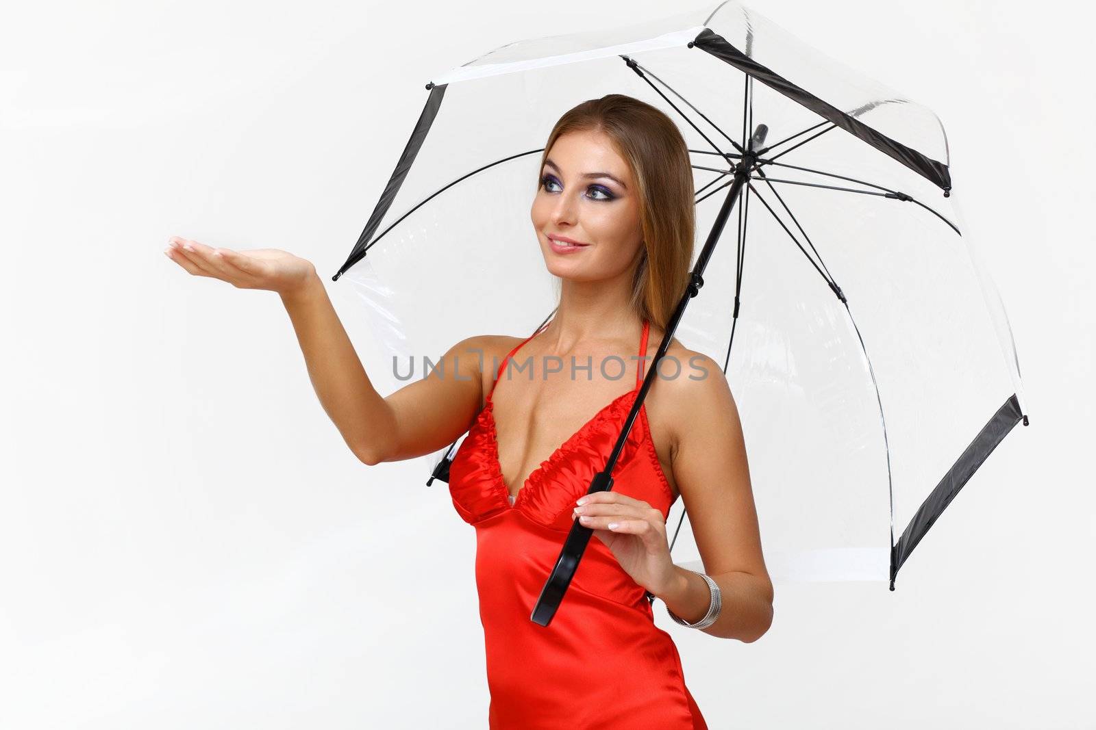 Portrait of young woman with umbrella in studio