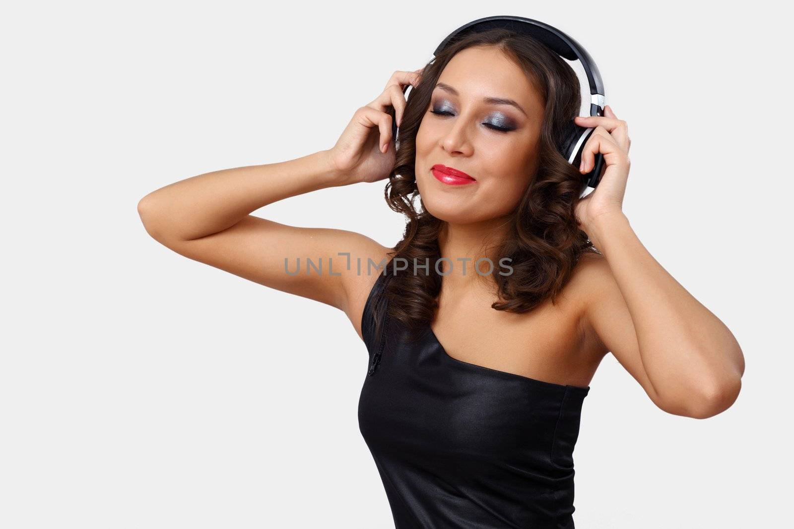 Portrait of young woman with headphones in studio