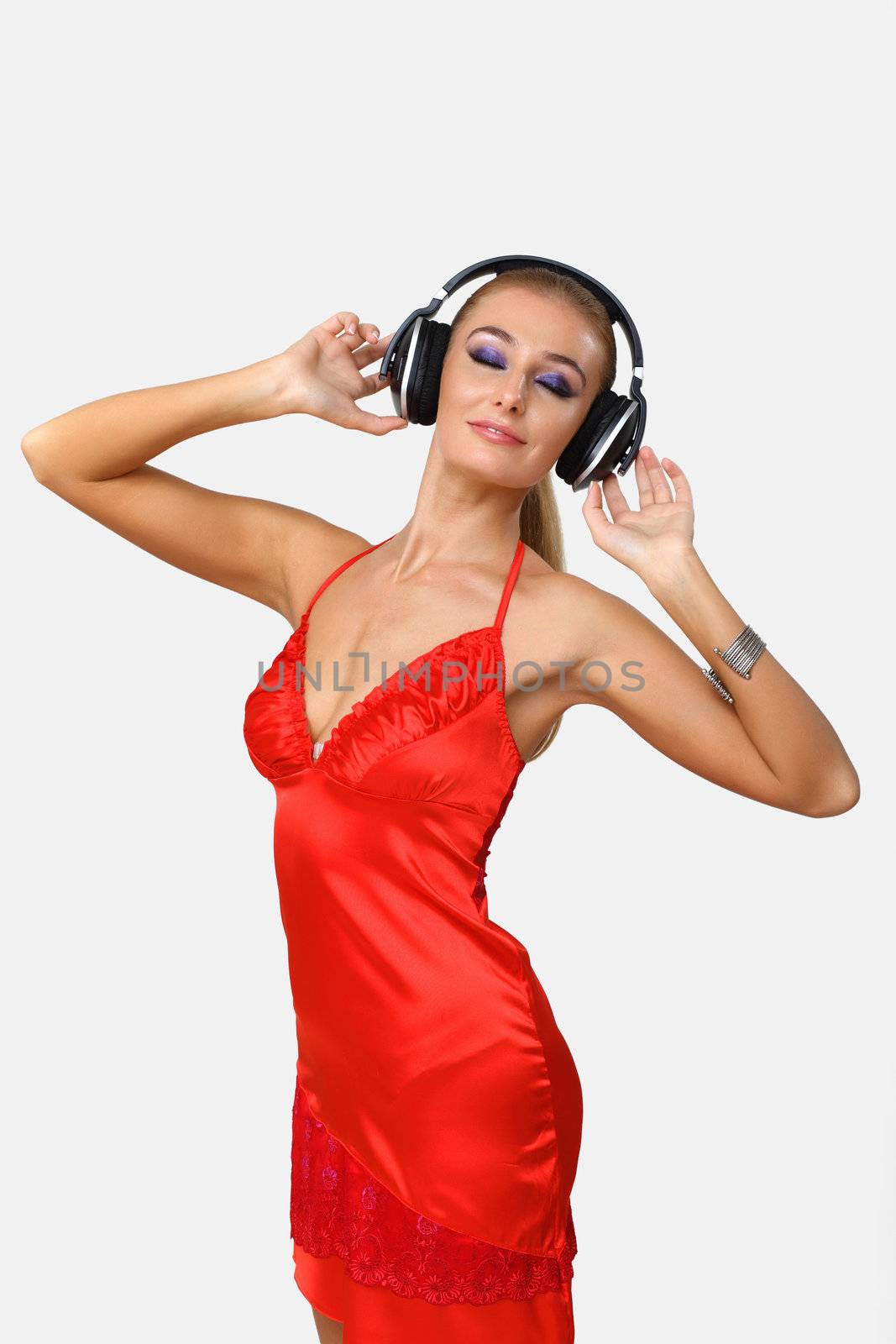 Portrait of young woman with headphones in studio