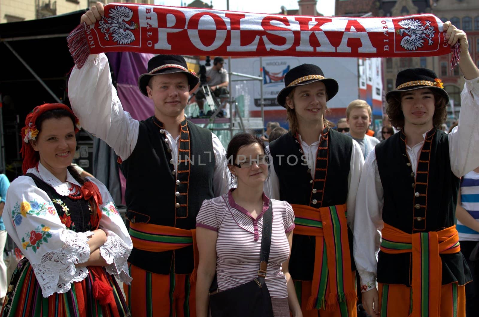 WROCLAW, POLAND - JUNE 15:  Members of Folk Dance group "Wroclaw" visit Euro 2012 fanzone. Dancers take photo with football fan on June 15, 2012 in Wroclaw.  