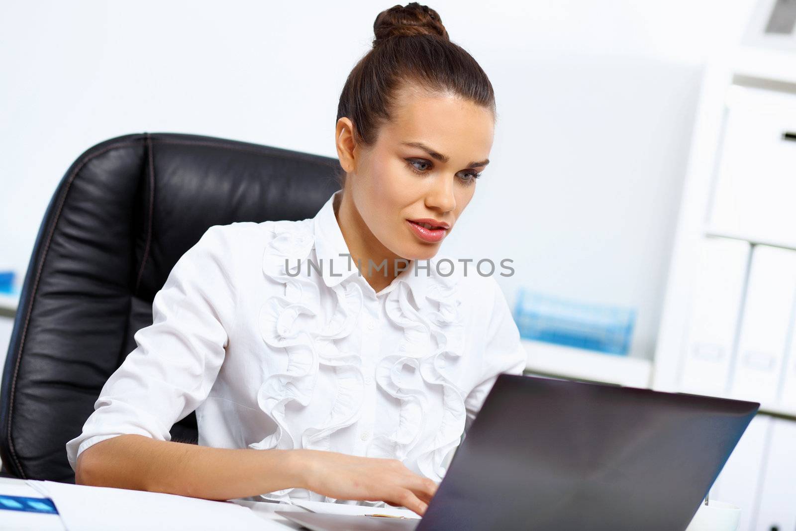 Young manager working with notebook in the office