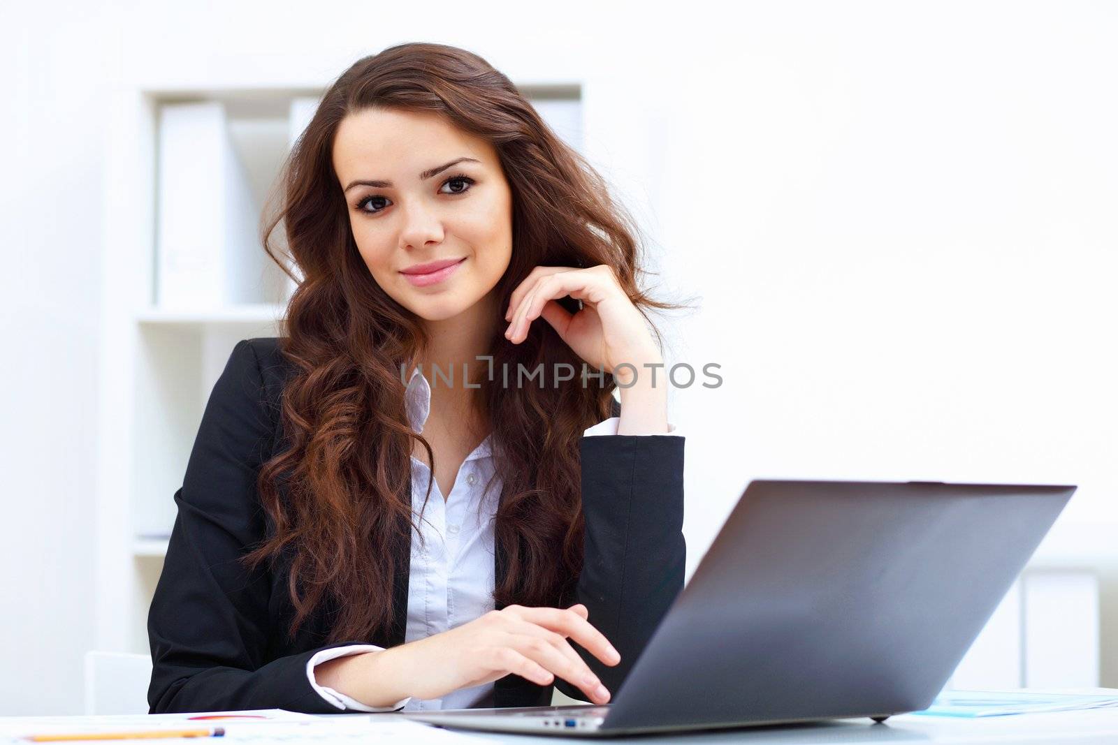 Young pretty business woman with notebook in the office