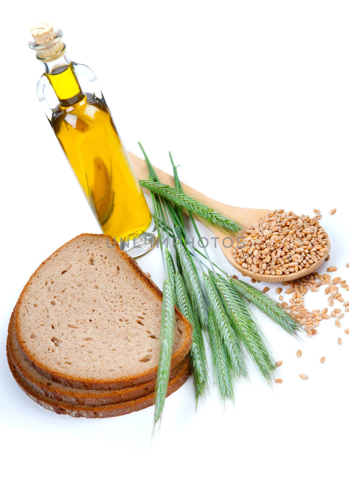 tasty baked bread with ears and wheat grain, isolated on a white background
