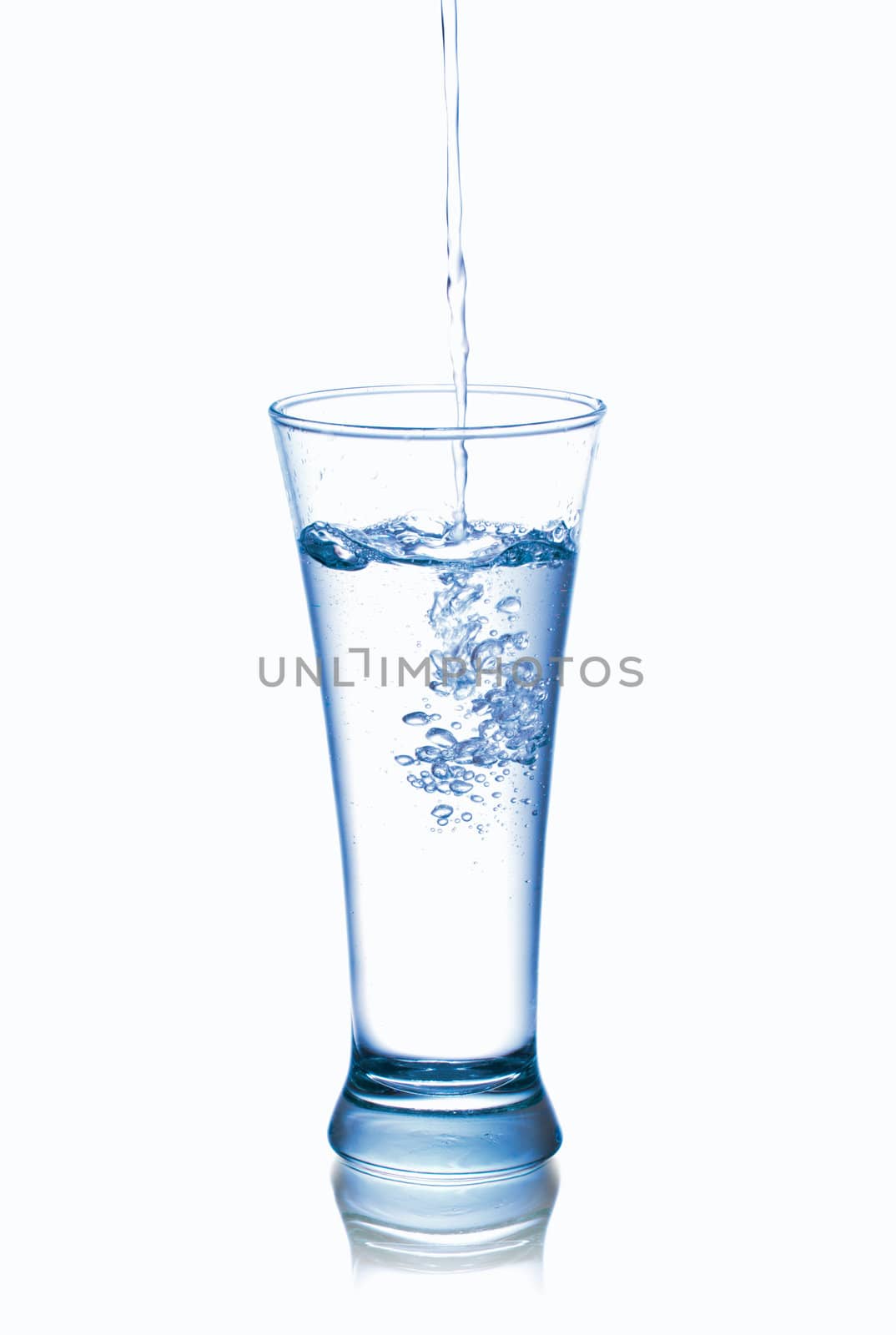 Photograph of pouring water into glass, isolated over white