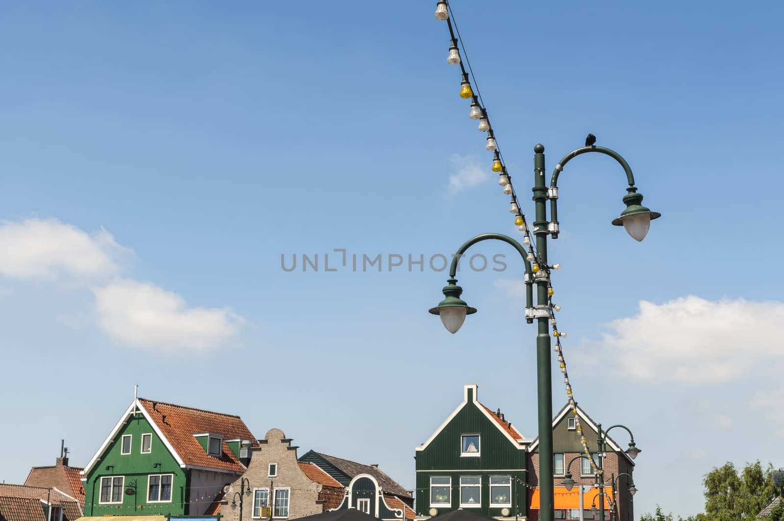 Detail of lamp post in Volendam, Holland, with traditional Dutch houses in the background