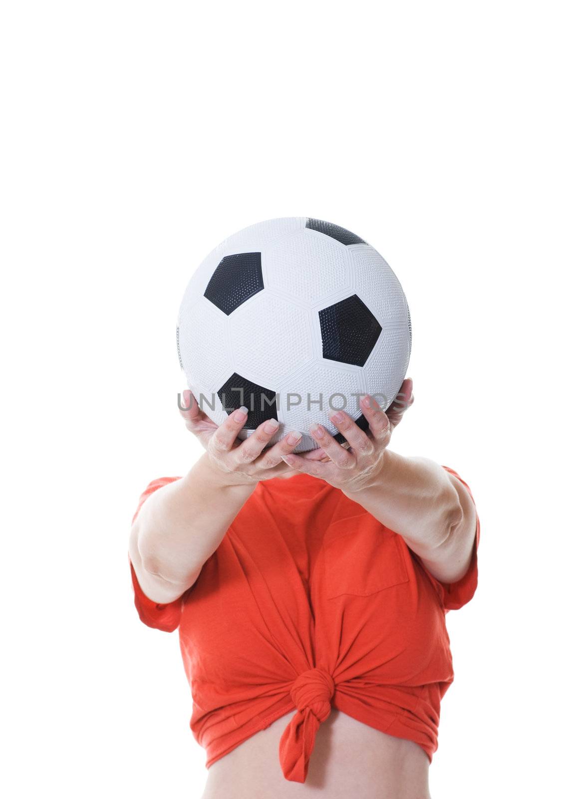 woman holding soccer ball in front of her face