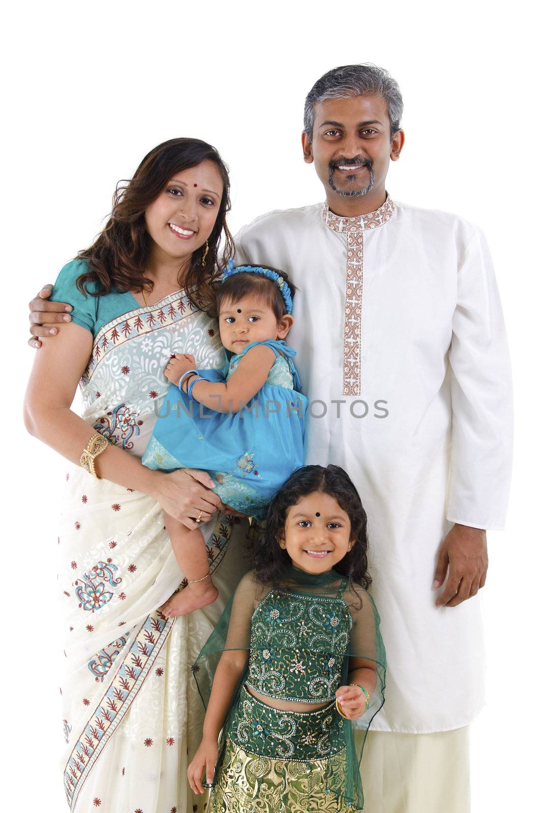 Happy traditional Indian family in traditional Indian costume standing on white background