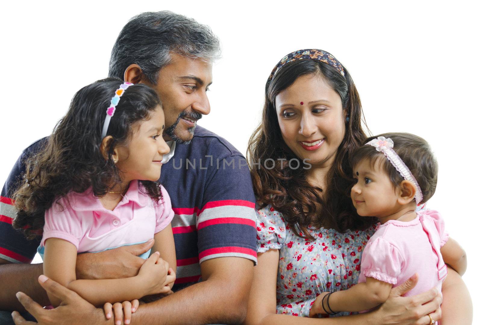 Modern Indian family with two daughter having conversation on white background