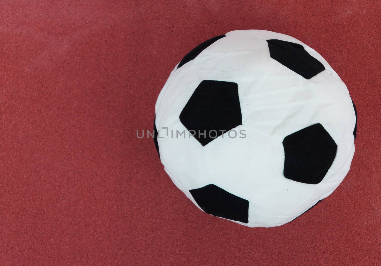 soccer ball with red cork board