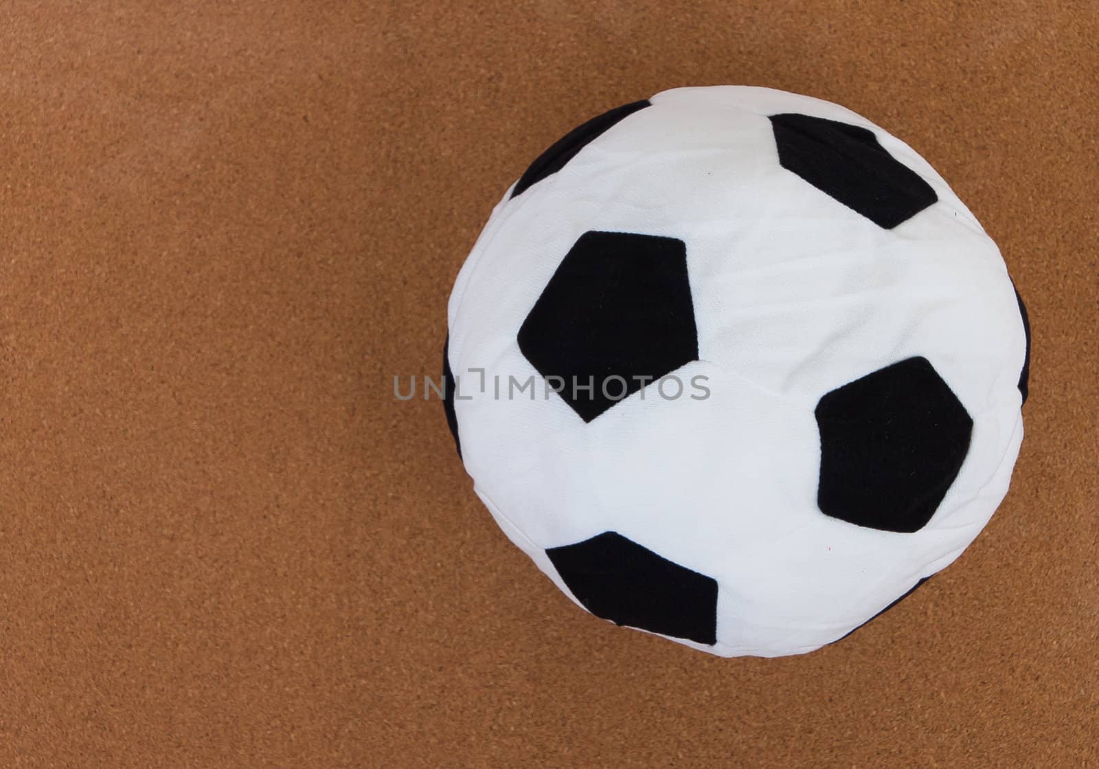 soccer ball with brown cork board