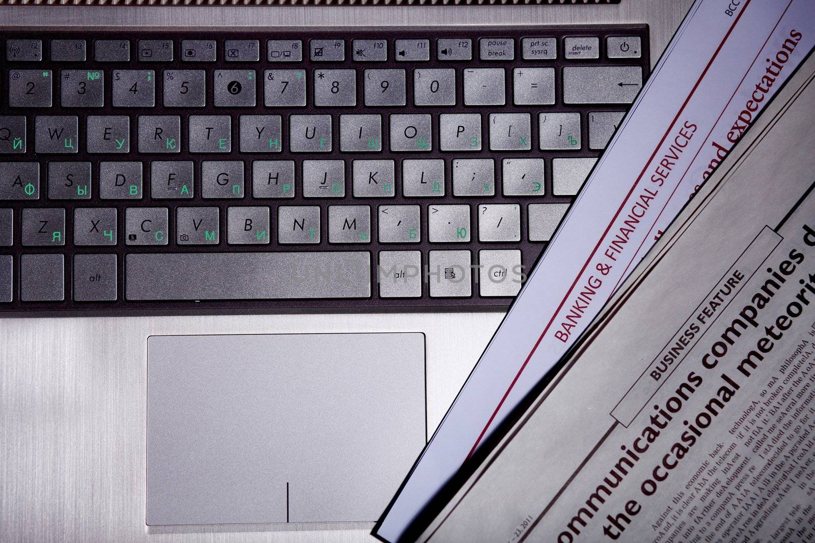 Notebook keyboard with a newspaper on it